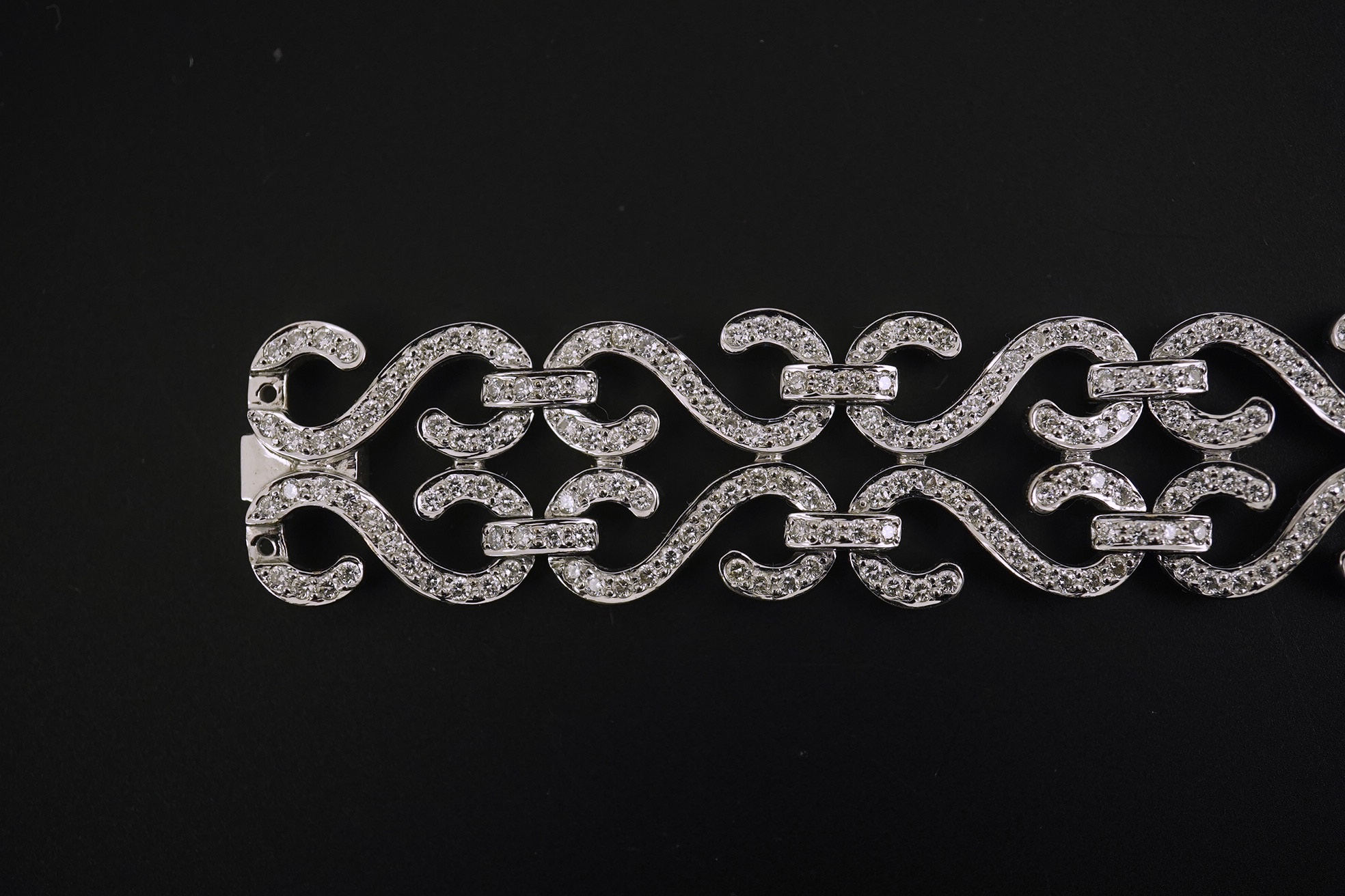 A modern 18k white gold and diamond chip cluster set bracelet